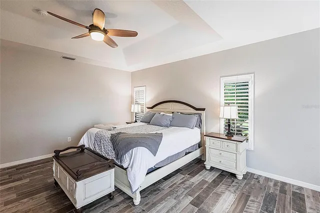 a spacious bathroom with a granite countertop double vanity sink a mirror and a bathtub