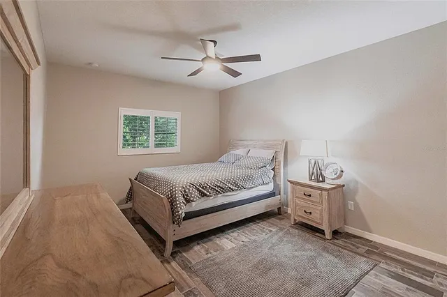 a bedroom with a bed and a lamp on dresser