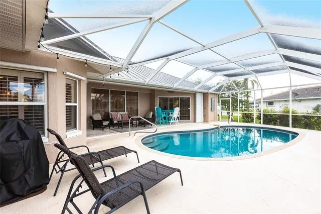 an aerial view of a house with a swimming pool yard and outdoor seating
