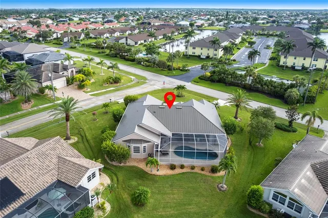 an aerial view of residential houses with outdoor space and street view