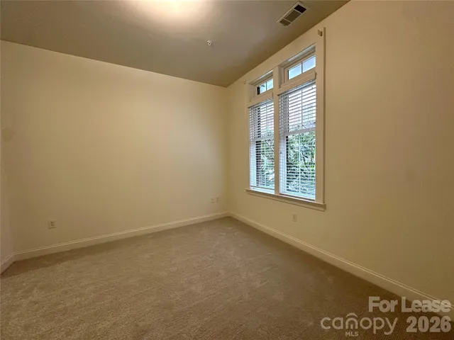 a bathroom with a granite countertop sink toilet a mirror and shower
