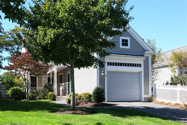 48 Turnberry Road, Unit 48 Bourne, MA 02532 - Photo 1 of 20 a front view of a house with a yard and garage
