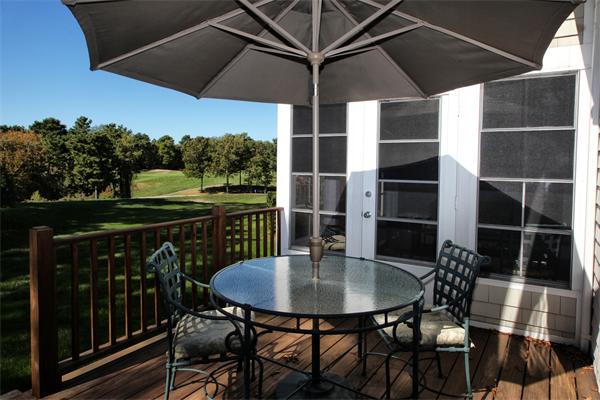 48 Turnberry Road, Unit 48 Bourne, MA 02532 - Photo 16 of 20 a balcony with table and chairs