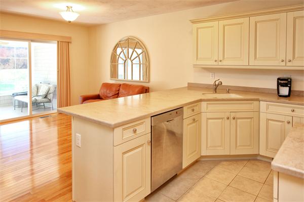 48 Turnberry Road, Unit 48 Bourne, MA 02532 - Photo 4 of 20 a kitchen with white cabinets and sink
