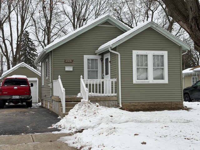 229 South Edison Avenue Elgin, IL 60123 - Photo 5 of 7 a front view of a house with a yard and garage