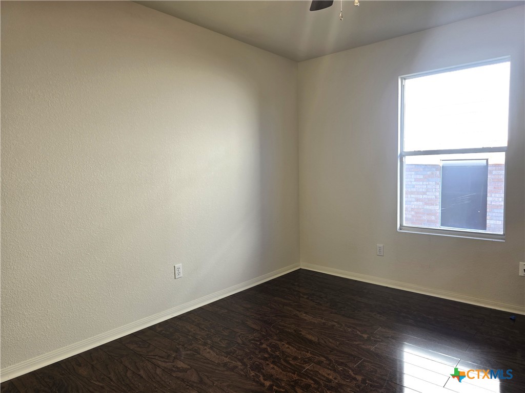 2203 Riley Drive Killeen, TX 76542 - Photo 17 of 22 an empty room with wooden floor and windows