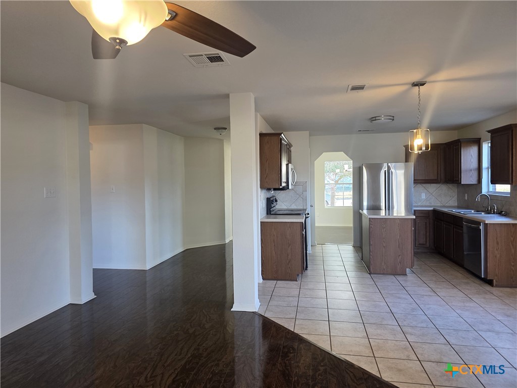 2203 Riley Drive Killeen, TX 76542 - Photo 9 of 22 a view of kitchen with stainless steel appliances wooden floor and large window