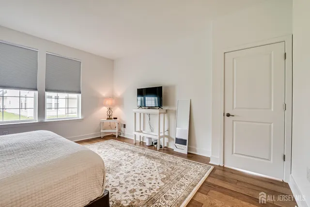 a bedroom with a bed and flat screen tv