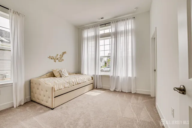 a spacious bedroom with a bed and a window