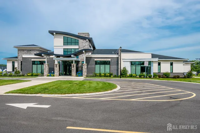 a front view of a building with a garden