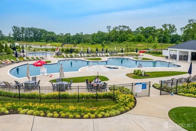 a swimming pool with outdoor seating and yard