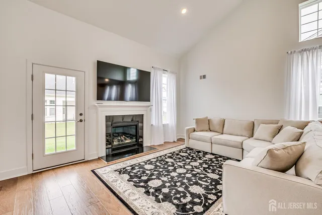 a living room with furniture a fireplace and window