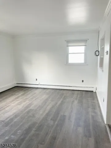 wooden floor and cabinet in an empty room