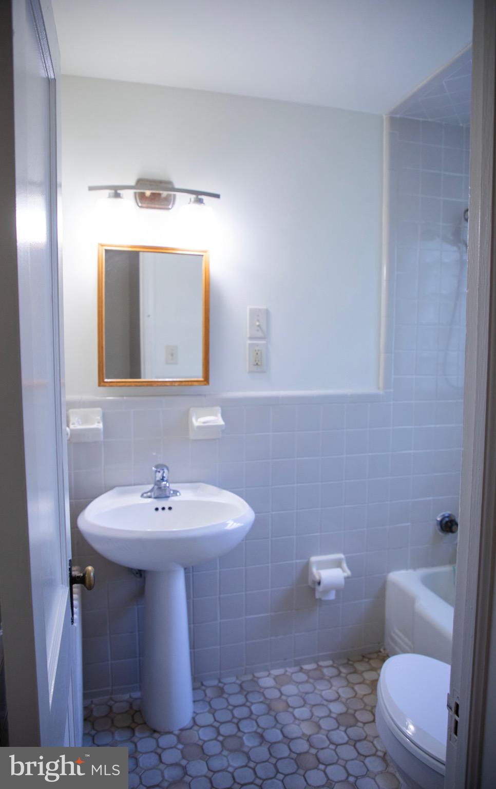 9406 Seminole Street Silver Spring, MD 20901 - Photo 12 of 32 a bathroom with a toilet sink and mirror