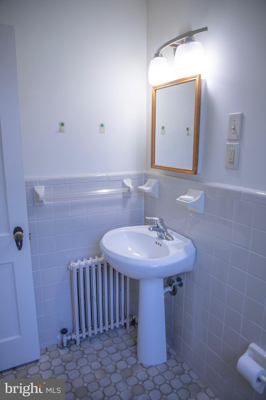 9406 Seminole Street Silver Spring, MD 20901 - Photo 14 of 32 a bathroom with a sink a toilet and shower