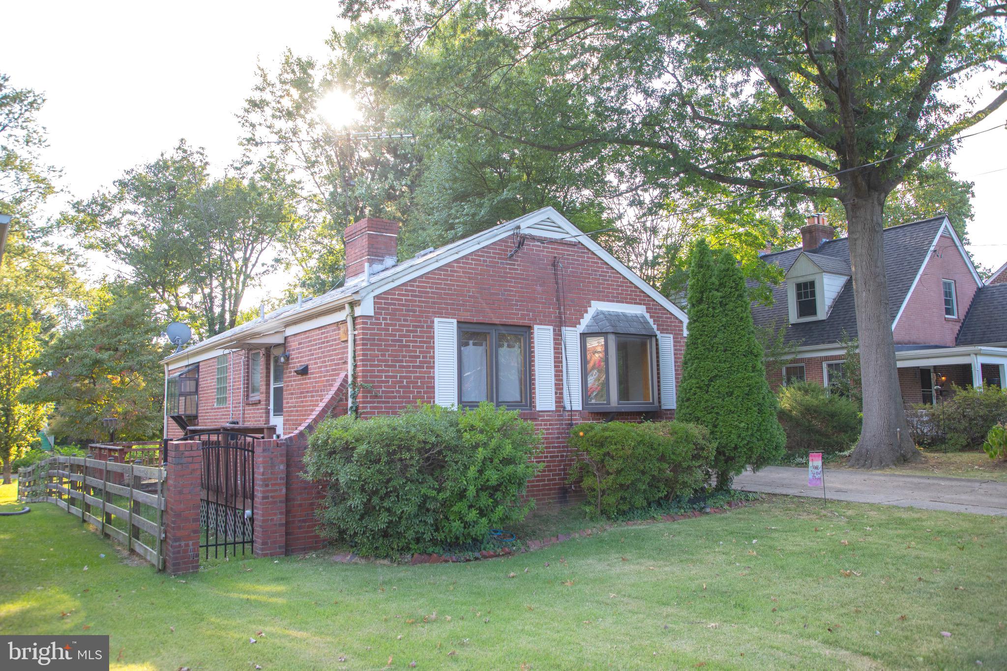 9406 Seminole Street Silver Spring, MD 20901 - Photo 2 of 32 a view of a yard in front of a house with plants and large tree