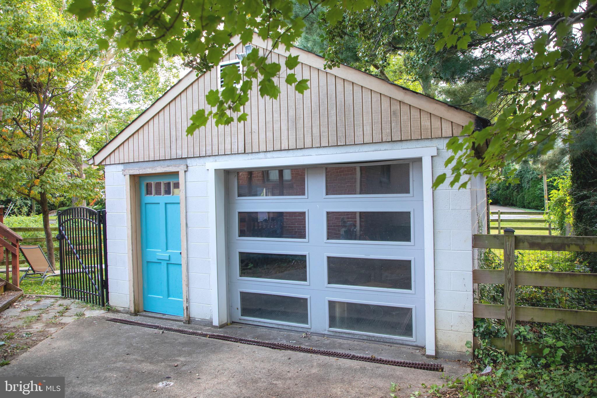 9406 Seminole Street Silver Spring, MD 20901 - Photo 23 of 32 a backyard of a house with wooden fence and large trees