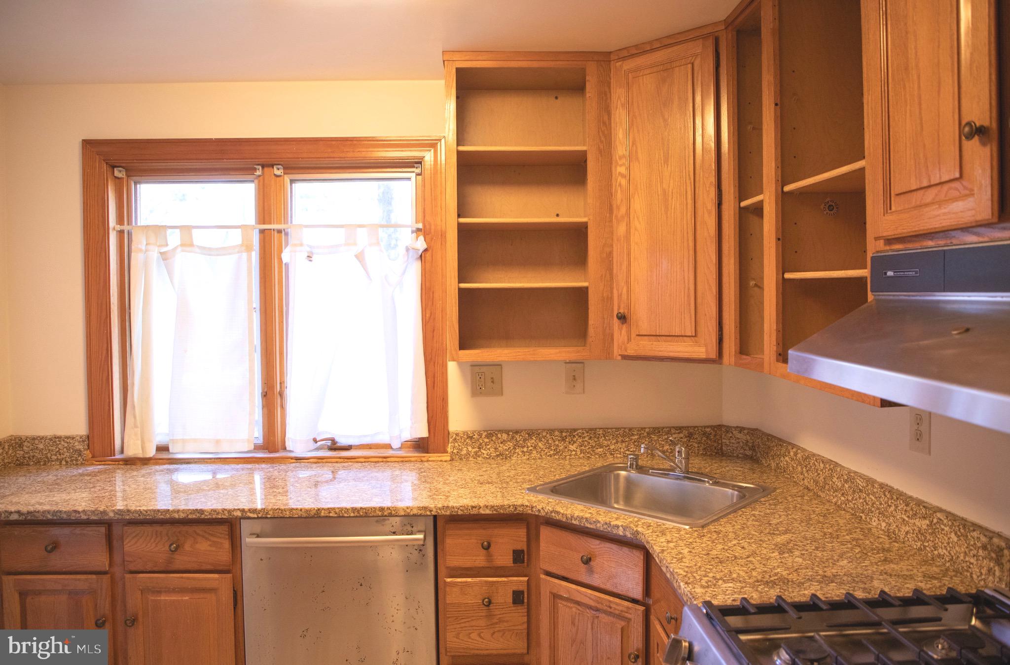 9406 Seminole Street Silver Spring, MD 20901 - Photo 9 of 32 a kitchen with granite countertop a sink and a window