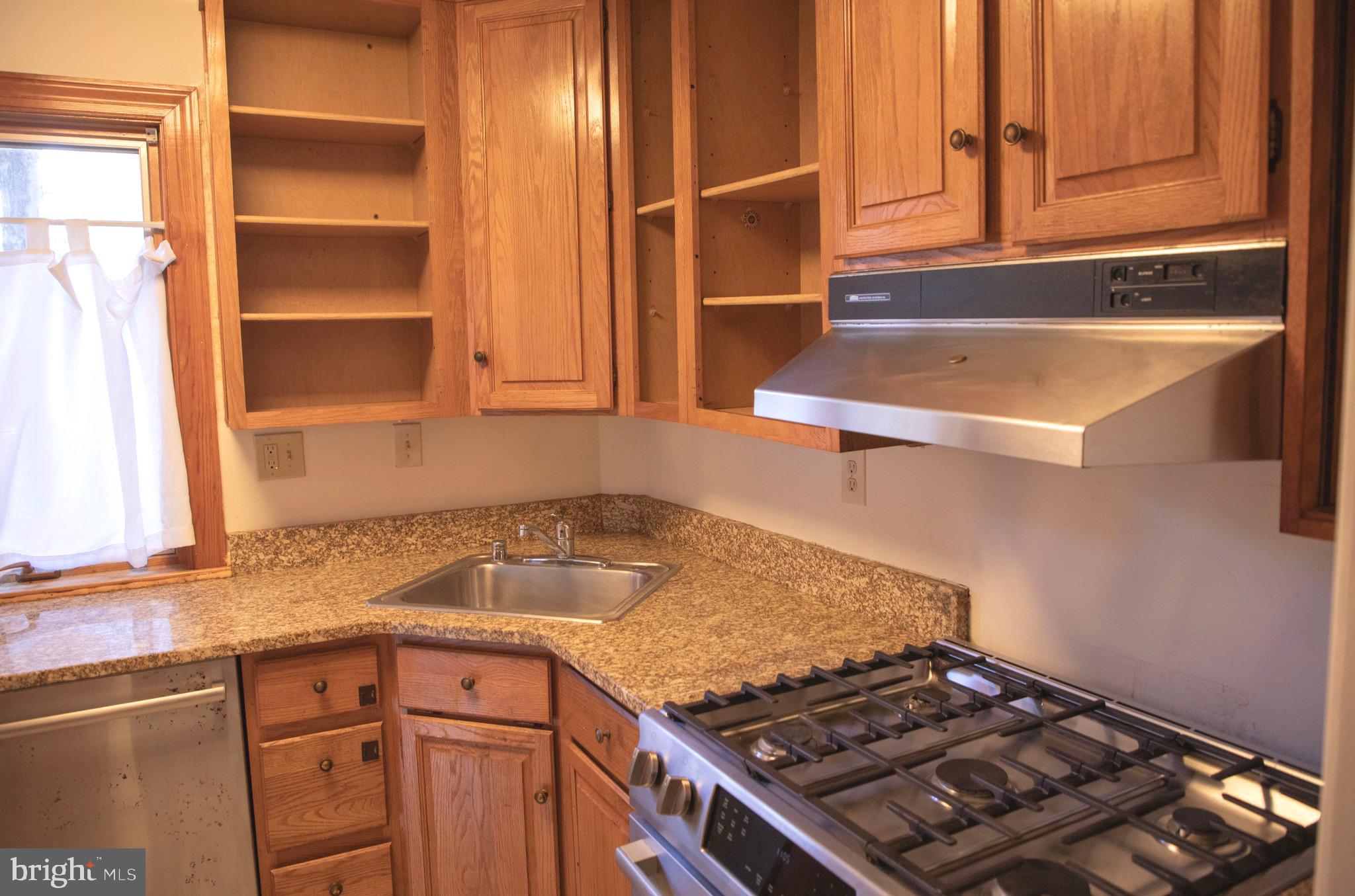 9406 Seminole Street Silver Spring, MD 20901 - Photo 10 of 32 a kitchen with a stove and a sink