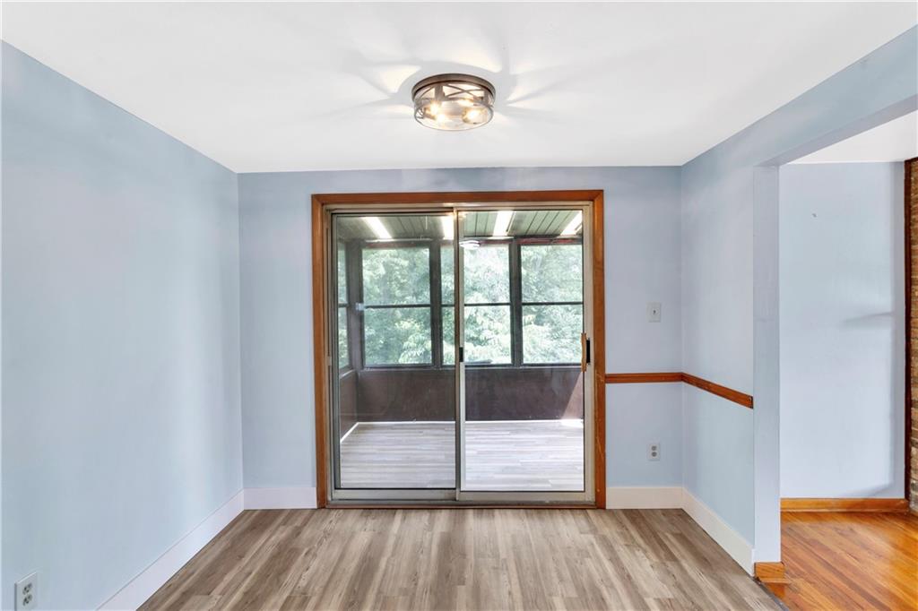 51 Revo Road Pittsburgh, PA 15236 - Photo 11 of 38 Sliding glass doors from the dining room lead directly into the sunroom.