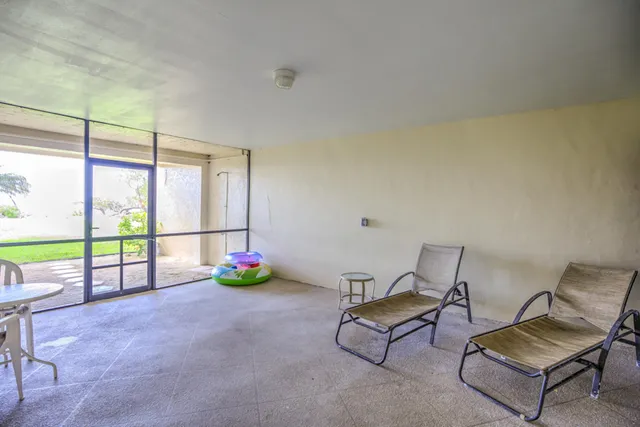 a view of swimming pool with outdoor seating and yard in back