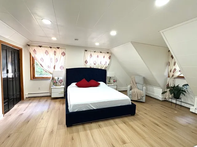a bedroom with a large bed and a window