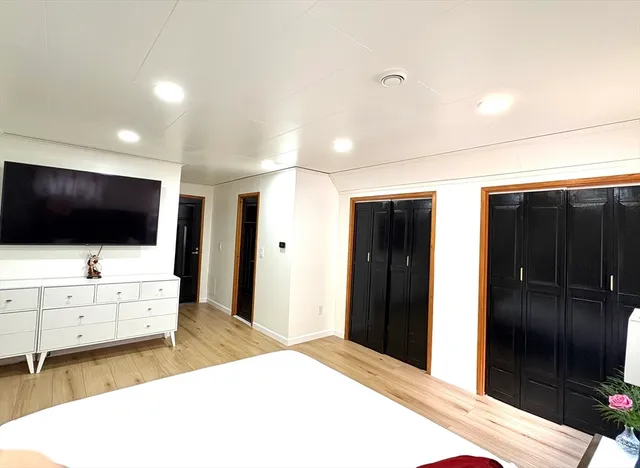 a living room with flat screen tv and refrigerator