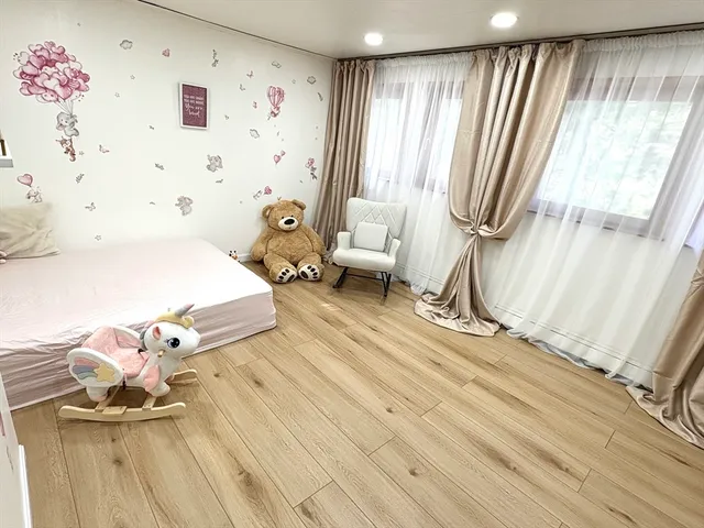 a spacious bedroom with a bed and a window