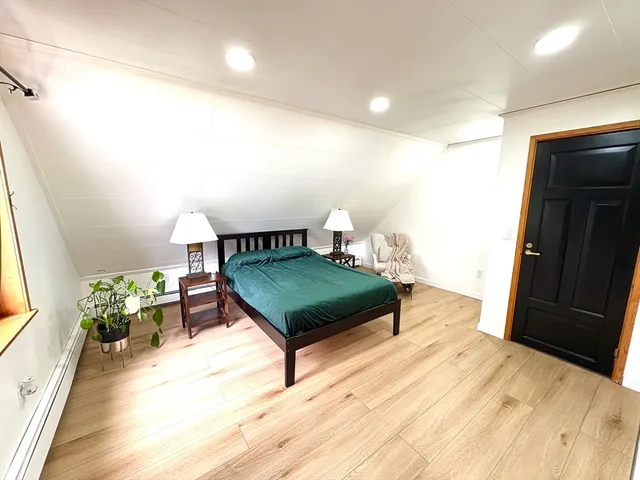 a bedroom with furniture and a wooden floor