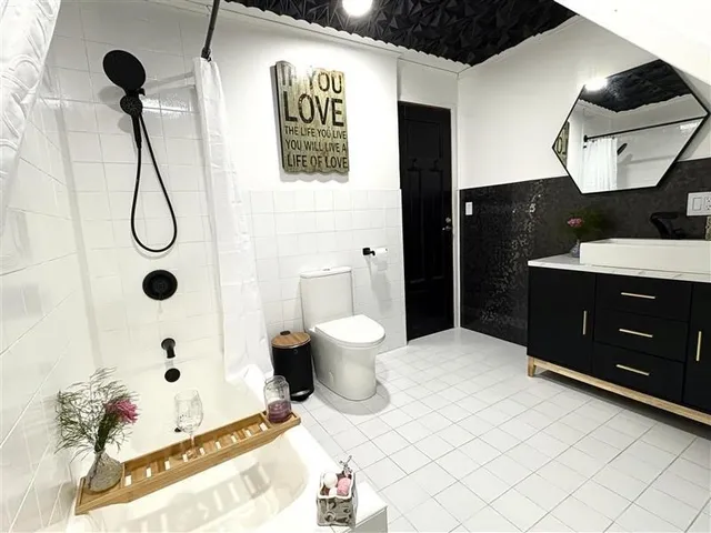 a bathroom with a sink mirror and toilet