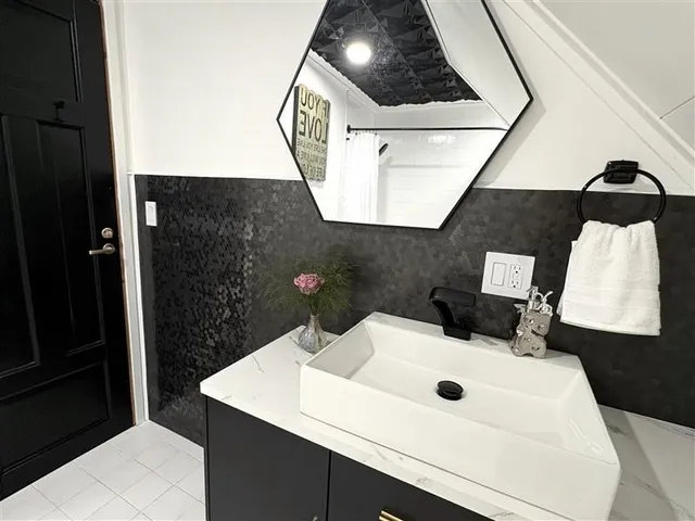 a bathroom with a sink and mirror