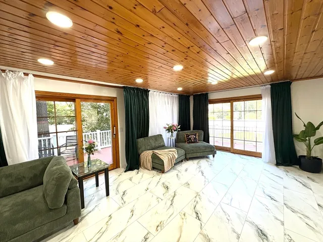 a bedroom with furniture and a large window