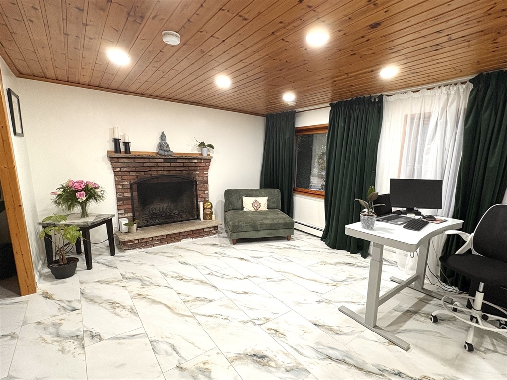 2 Pat Drive Danvers, MA 01923 - Photo 7 of 29 a living room with furniture a fireplace and a flat screen tv