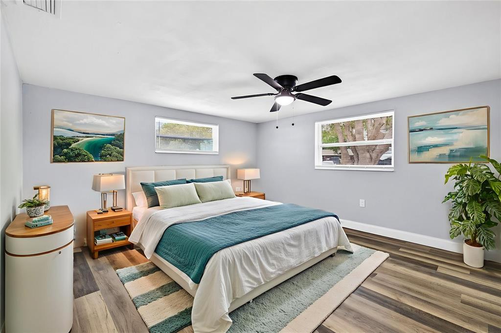 3420 Chickadee Drive Holiday, FL 34690 - Photo 12 of 15 a bedroom with a large bed and a chandelier