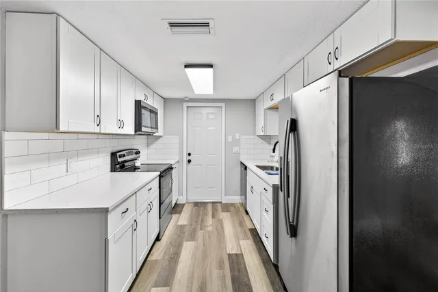 a kitchen with a refrigerator a sink and dishwasher