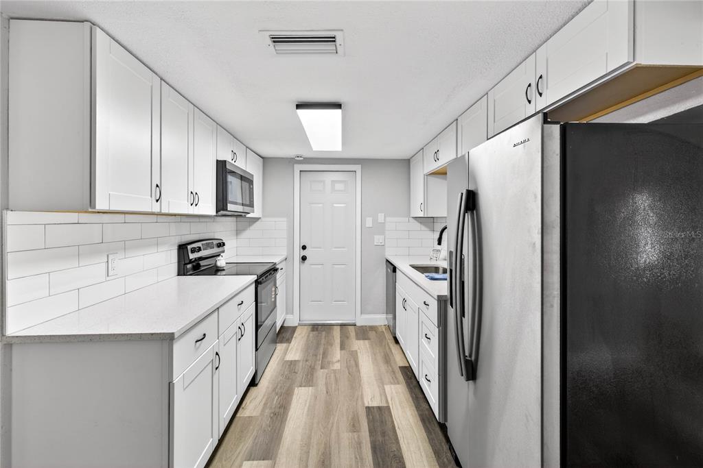 3420 Chickadee Drive Holiday, FL 34690 - Photo 5 of 15 a kitchen with a refrigerator a sink and dishwasher
