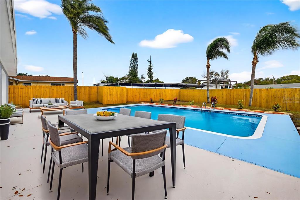 3420 Chickadee Drive Holiday, FL 34690 - Photo 9 of 15 a view of swimming pool with outdoor seating and ocean view