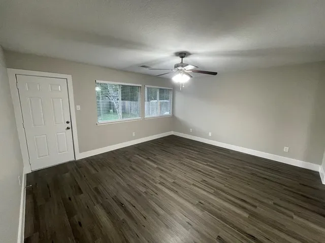 wooden floor in an empty room with a window