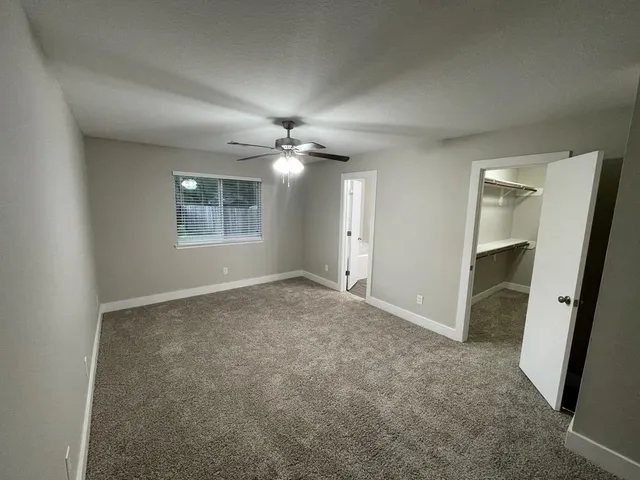 en empty room with windows and entrance