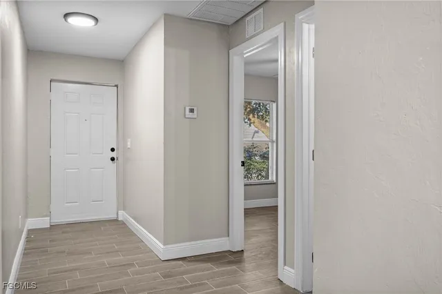 an empty room that has a wooden cupboard