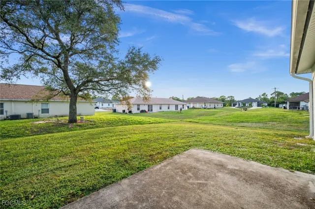 a view of a garden with a building in the background