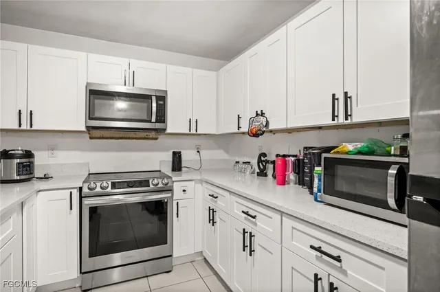 a kitchen with stainless steel appliances a stove microwave and cabinets