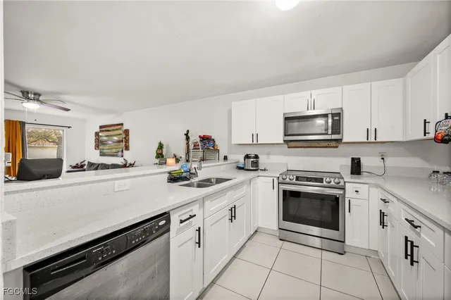 a kitchen with cabinets stainless steel appliances and sink