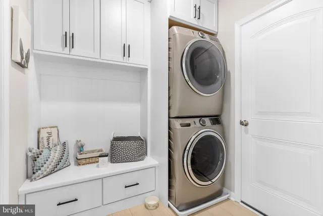 a utility room with sink dryer and washer