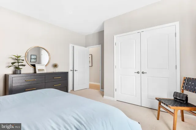 a bedroom with a bed and a dresser