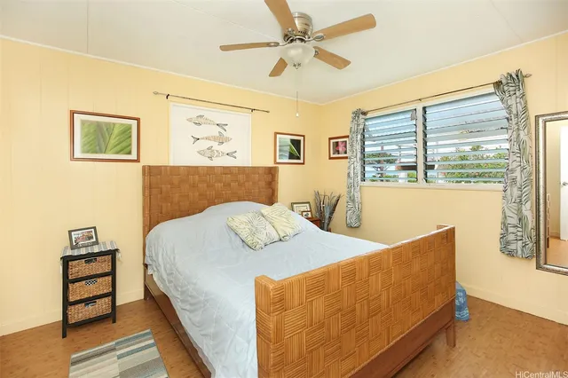 a bed sitting in a bedroom next to a window