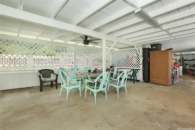 a dining room with furniture a chandelier and a projector
