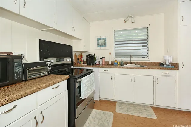 a kitchen with stainless steel appliances granite countertop a sink and a stove