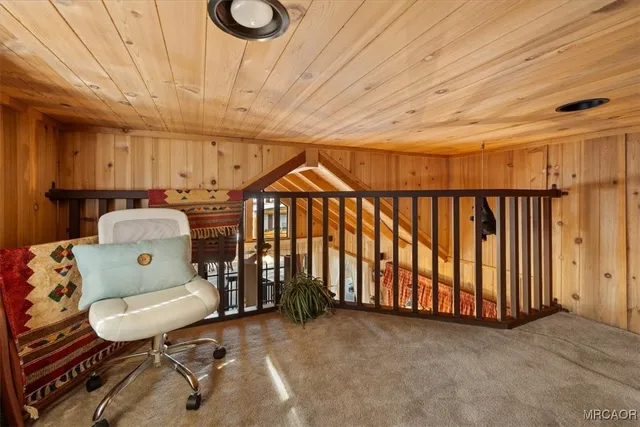 a view of a hallway with furniture