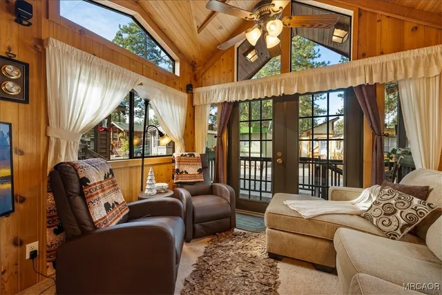 a bedroom with furniture a ceiling fan and a window